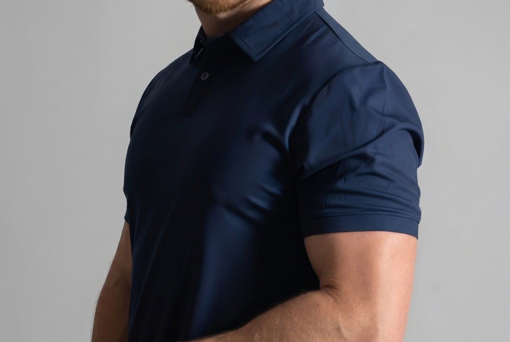 shoulder and bicep close up view with man in a dark blue polo from ten10 apparel