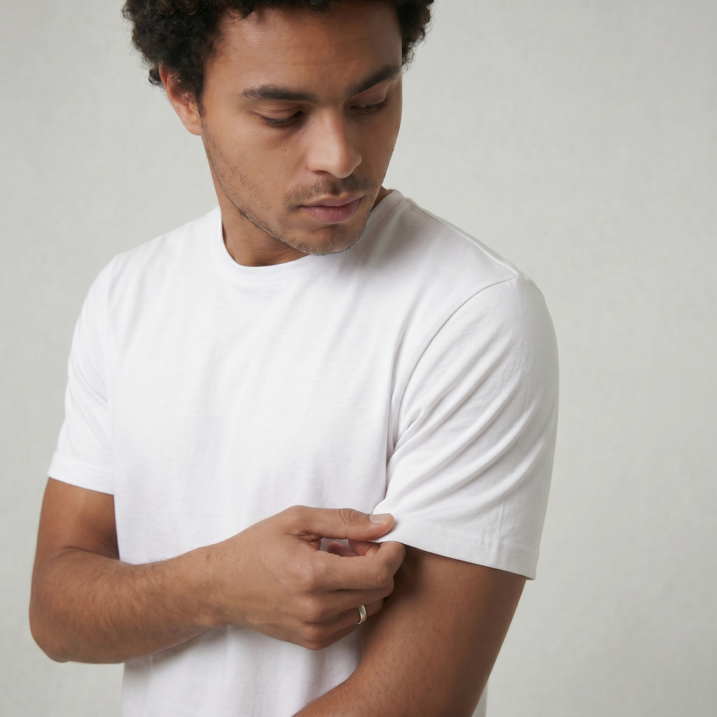 man holding sleeve of white luxury tee