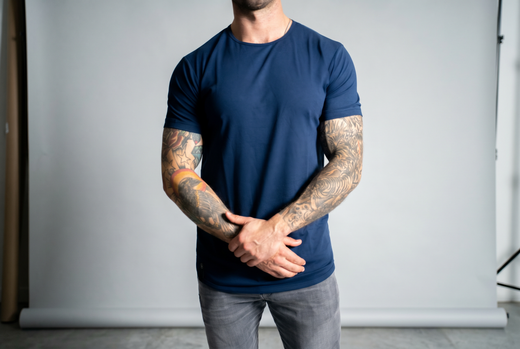 Oxford blue curved hem tee from ten10 apparel. Guy with tattoos wearing shirt.