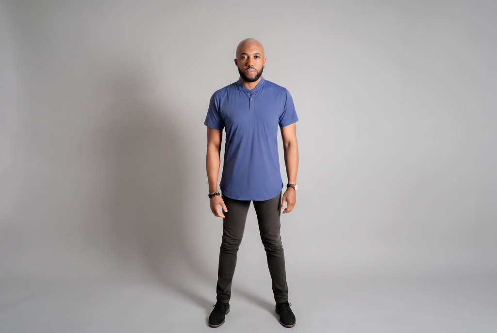 man in mock neck blue polo with black pants on
