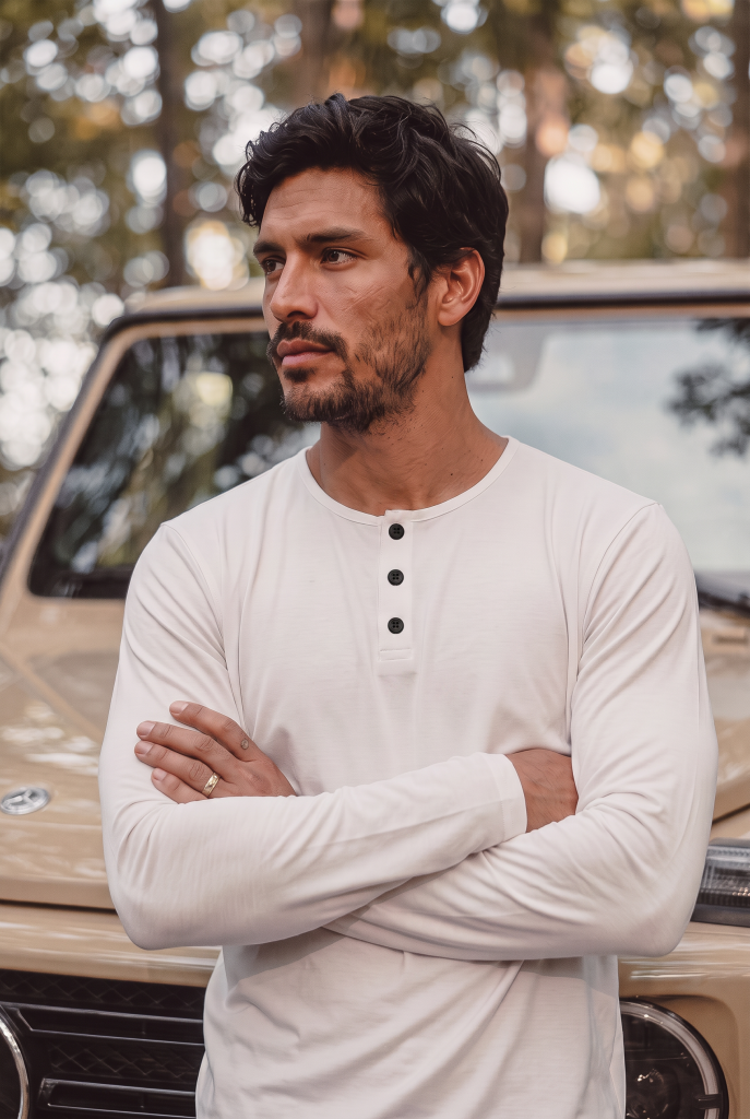 Man in white long sleeve with black buttons for transitional fall weather